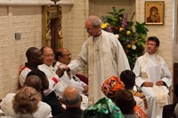 Archbishop Welby shows Archbishop Idowu-Fearon the plumb from the 14th-century plumb line discovered recently at Lambeth Palace.