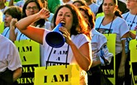 Protesters in a rally for immigrant  workers in Los Angeles carry signs reading "I Am A Human Being."