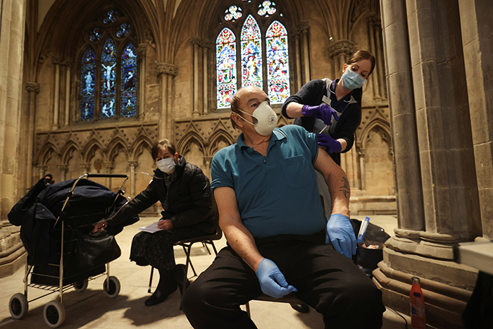 Carl -Recine -Reuters _Man -receives -Covid -19-vaccine -Lichfield -Cathedral -Staffordshire -England -210115_700x 467